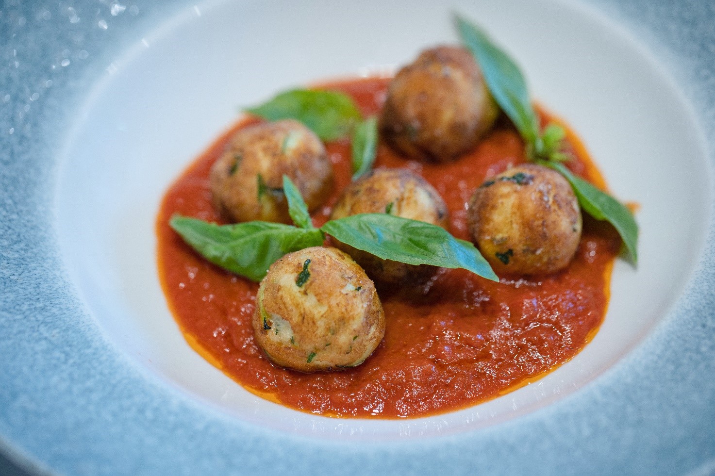 Fried courgette ricotta balls in tomato sauce